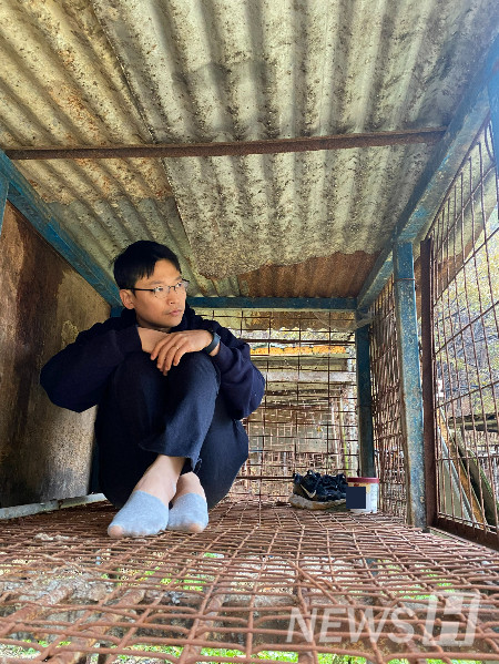 ▲ 남 기자는 세상에 들리지 않는 목소리에 귀를 기울이며 세상의 결을 섬세하게 조명한다. 개 농장의 철창 안에 있는 남 기자의 모습. ⓒ 남형도 기자