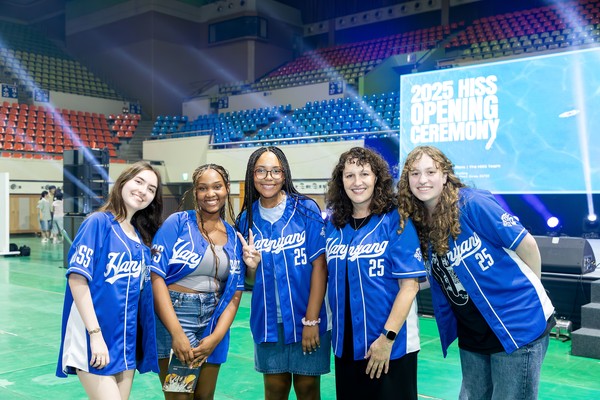 Participants from around the world wear matching uniforms and take a group photo at the hiss opening ceremony venue.