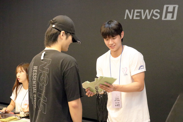 ▲ 爱心골드문 토토사이트宣传大使卢裕敏（经营学部 2）同学正在迎接参加OLLE营的高中生并分发名牌。