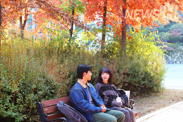 ▲ 가을빛으로 물든 벤치, 두 학생이 잔잔한 여유를 나누고 있다.